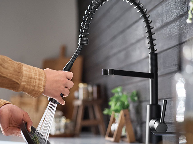 Black goosneck kitchen faucet in use - Weinstein Kitchen & Bath Showroom West Chester