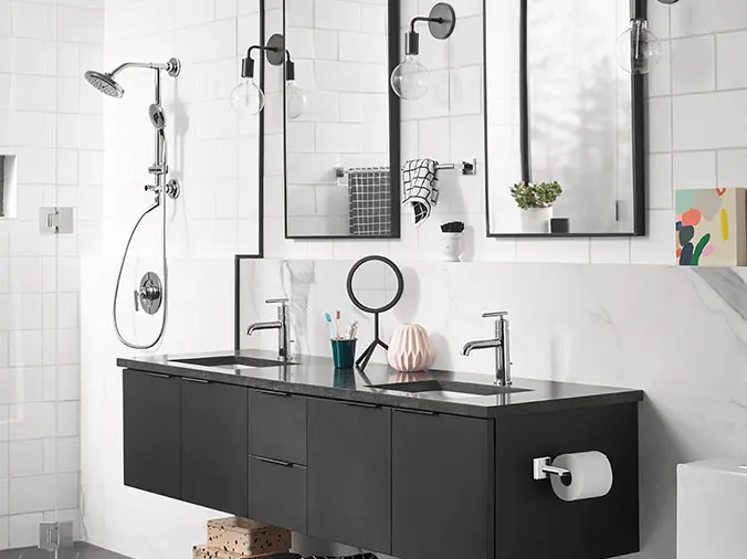 Black bathroom counter with black faucets - Weinstein Kitchen & Bath Showroom West Chester