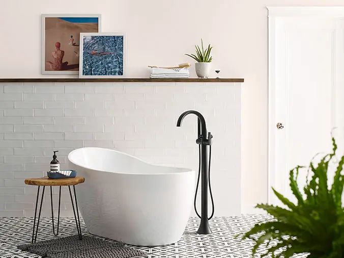 Free-staning bathtup with black faucet - Weinstein Kitchen & Bath Showroom West Chester
