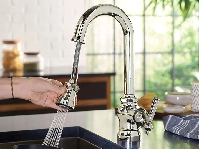Polished chrome kitchen faucet in use - Weinstein Wholesale Plumbing Supply West Chester
